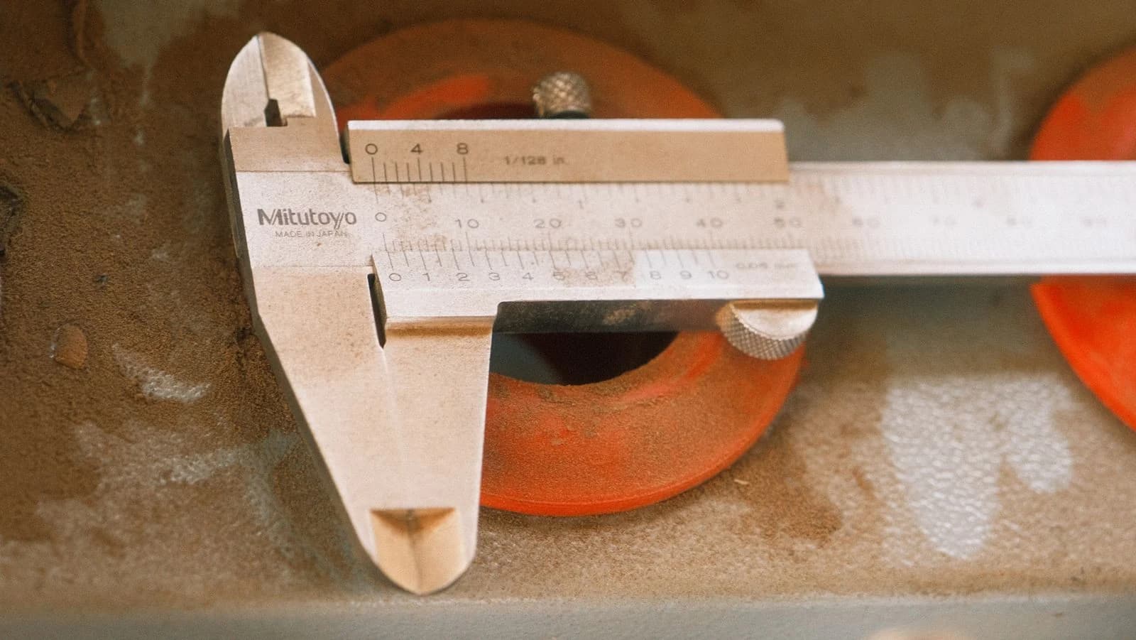 A caliper measuring a machined part