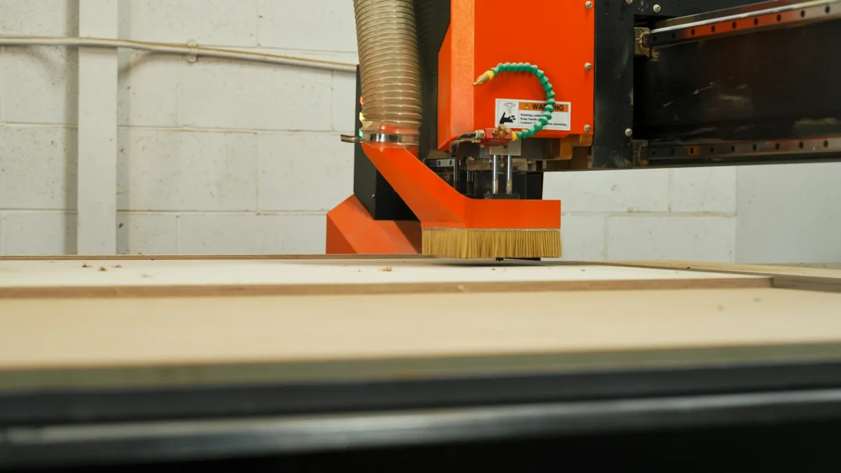A hand-drawn pencil sketch of a flat bracket on the left, an arrow, and the same shape as clean closed vector contours ready for a CNC router on the right