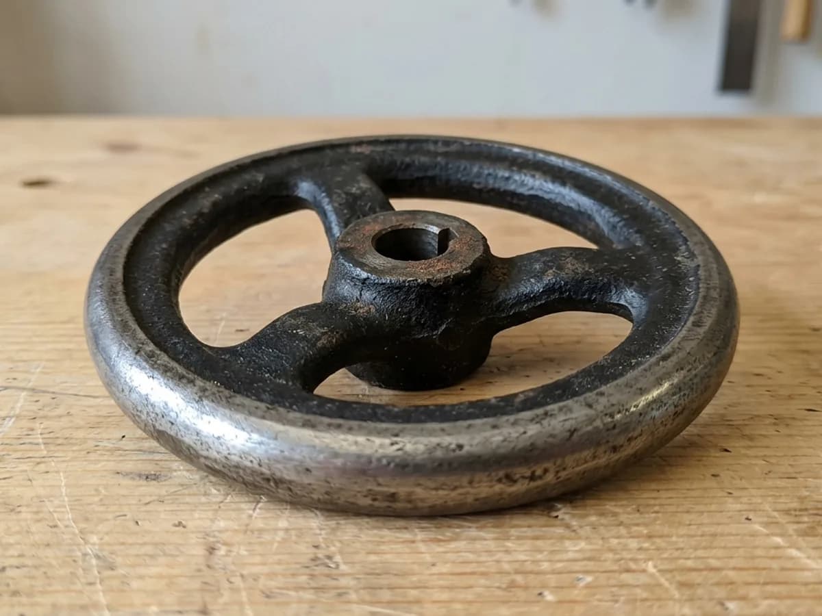 A photo of a knurled aluminium control knob on a workbench, ready to upload